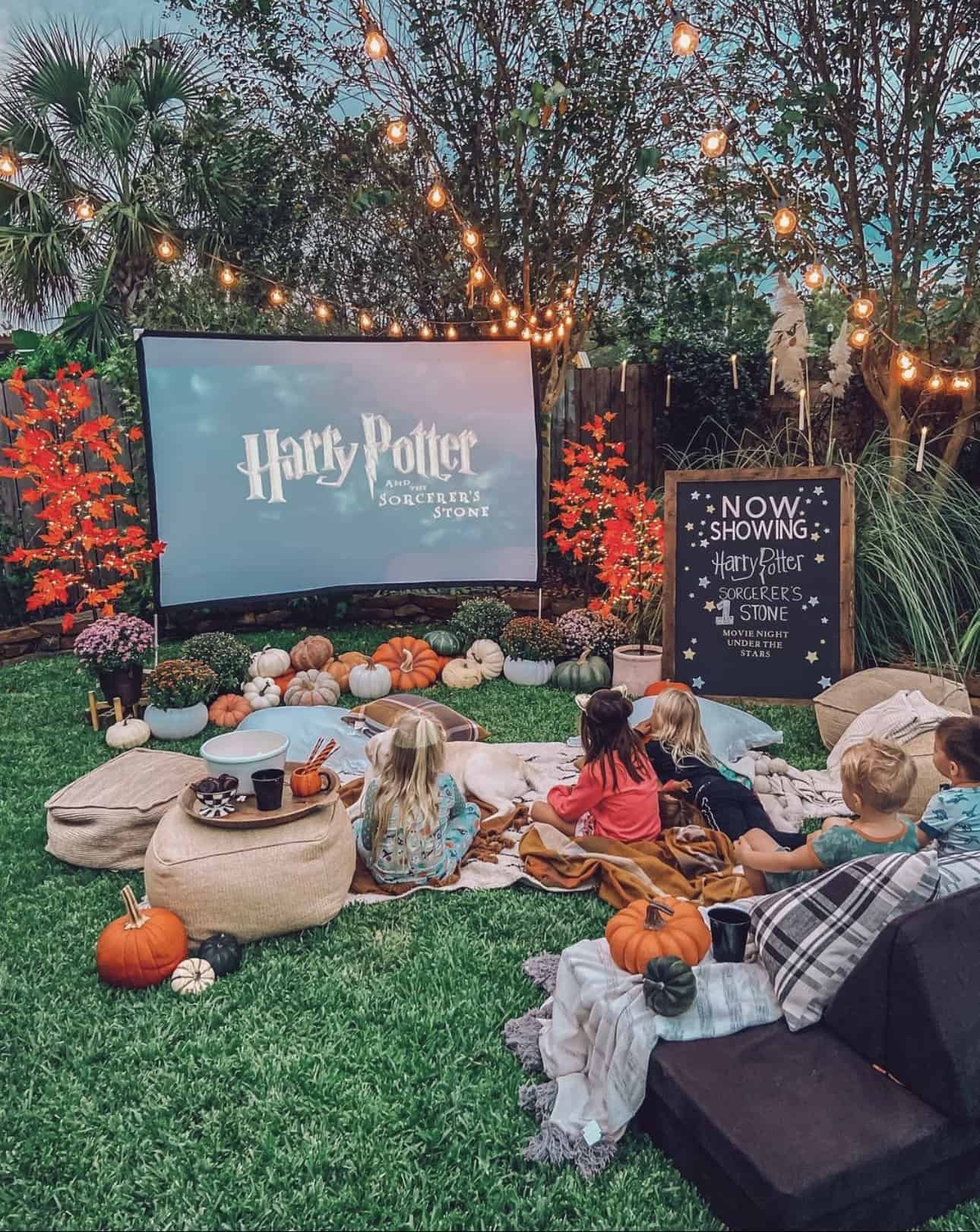 kids watching movie on lawn with blankets