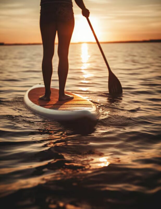 paddle boarder at sunset